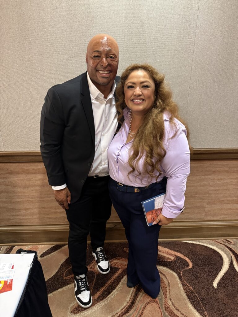 Desert Fast Pitch keynote speaker JR Martinez and SAFE FJC participant Selena Rodriguez smile together.